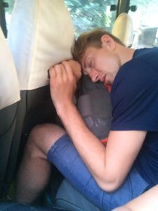 Mart sleeping on flexible on bus.